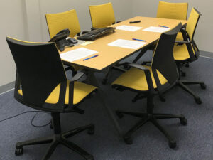 Office table with six yellow chairs. Commercial Interior Painting: Does Your Office Have These Paint Problems?